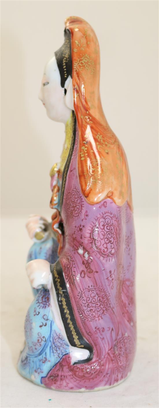 A Chinese famille rose enamelled porcelain seated figure of Guanyin, Jiaqing period, 21cm